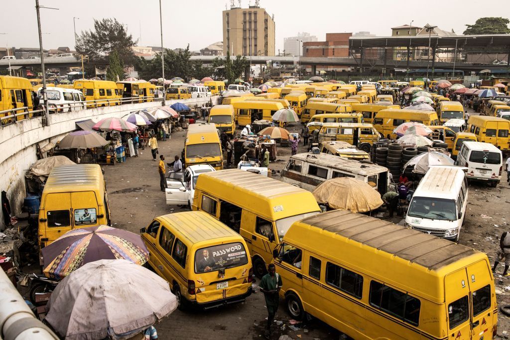 Bus drivers wait for customers at the Obalende Bridge in Lagos, Nigeria