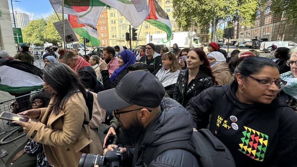 A group of demonstrators stage a rally outside the court to show solidarity with Ms Hussain