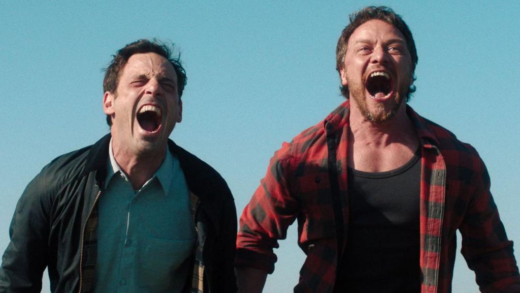 Scoot McNairy's Ben (left) cathartically screams on a hilltop with James McAvoy's Paddy (right)