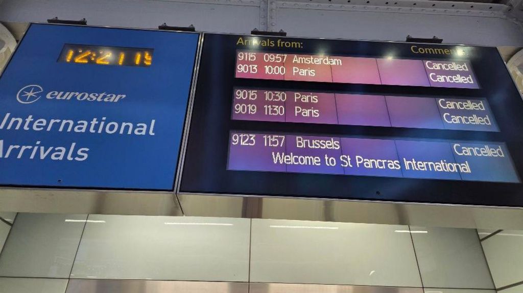 Departure boards at St Pancras station showing cancellations to Amsterdam, Paris and Brussels services
