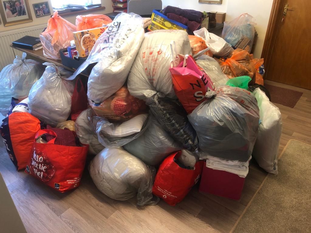 pile of donations in plastic bags 