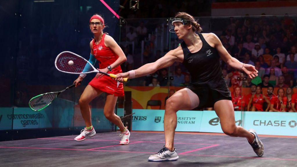 Joelle King of Team New Zealand and Alison Waters of Team England compete during the Mixed Doubles