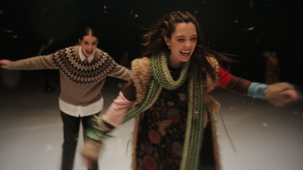 Two women ice skating, as part of a scene from the John Lewis Christmas advert