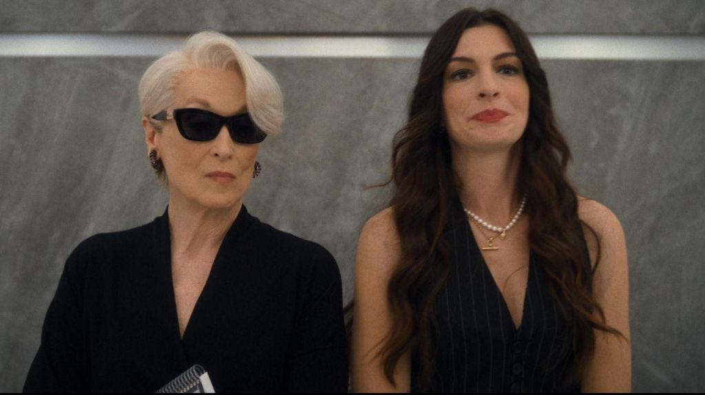 Meryl Streep and Anne Hathaway standing in a lift together in The Devil Wears Prada 2