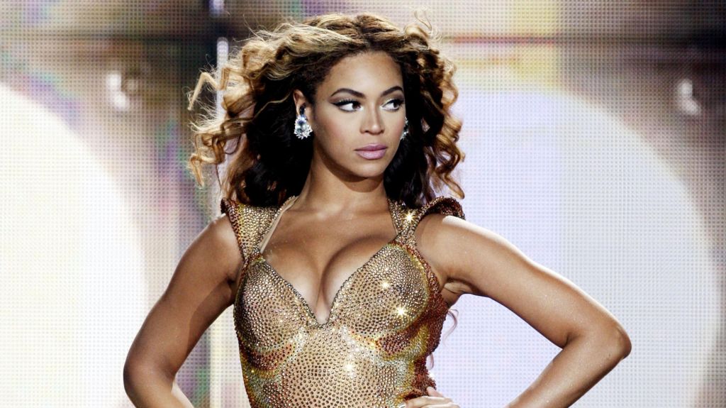 Beyoncé, pictured in 2009, glances to the side of the stage as she performs in a sparkling gold body suit