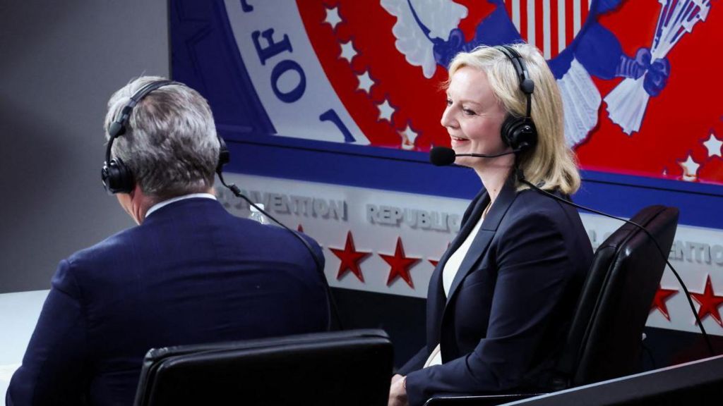 Liz Truss dressed in a suit and wearing a headset at the Republican National Convention in July