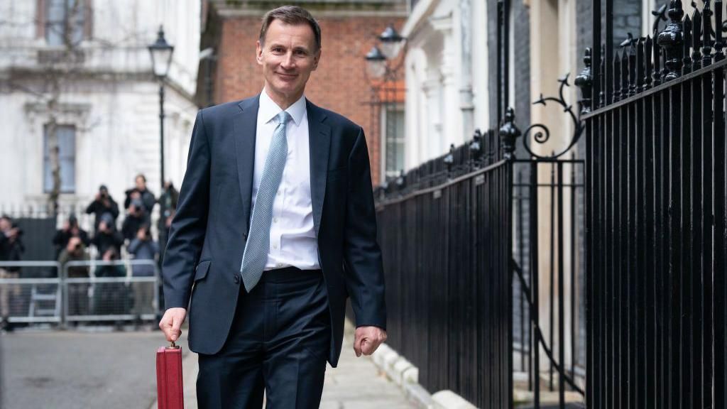 Jeremy Hunt on Budget day with the red briefcase