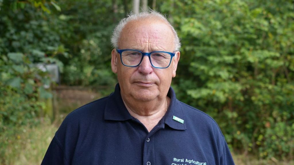 A portrait photo of rural chaplain Graham Miles with trees in the background