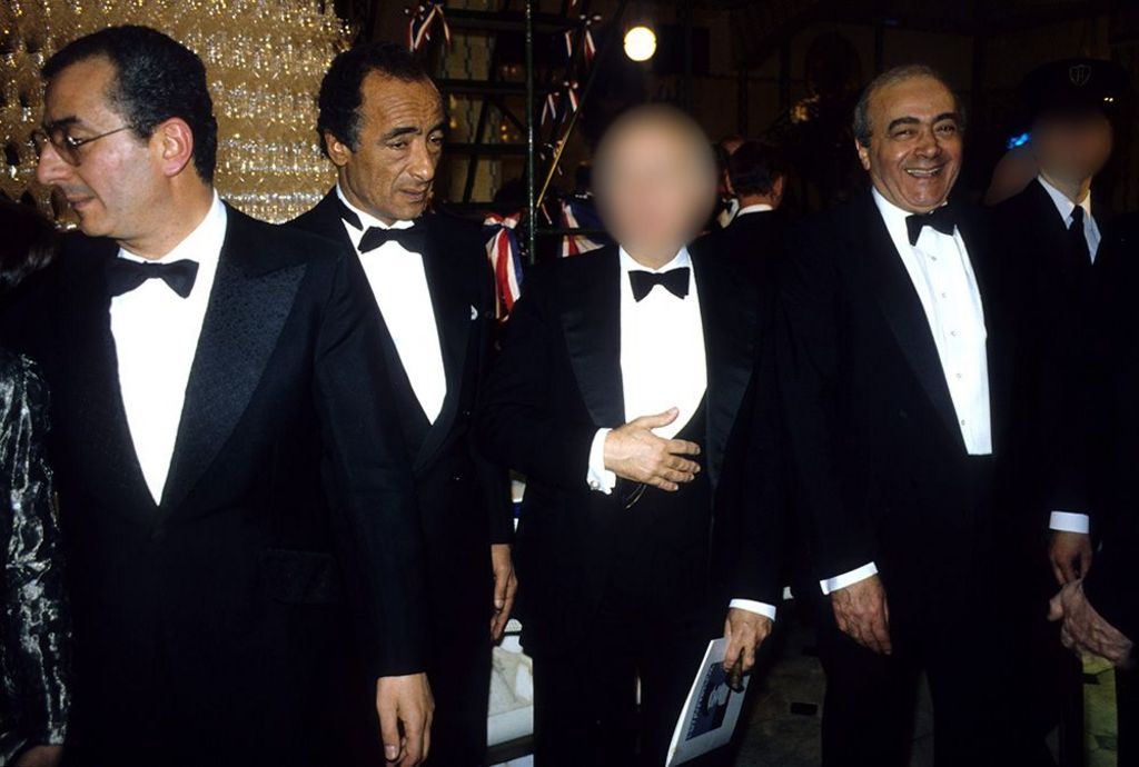 Ali with his brothers Salah and Mohamed (L-R). They are all dressed in black tie and Mohamed is smiling broadly at the camera.