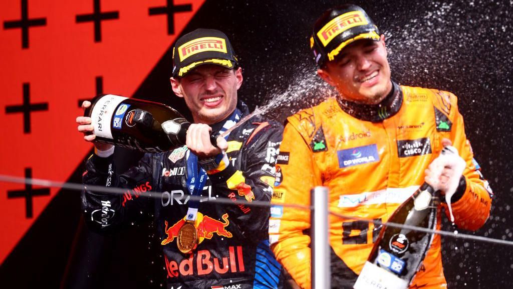 Max Verstappen sprays Lando Norris with champagne