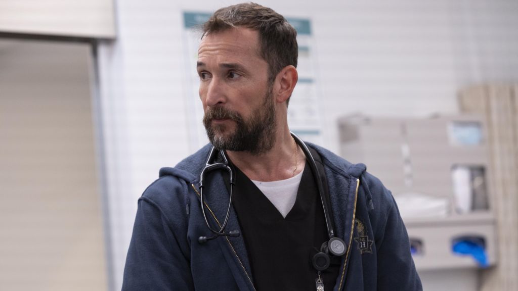 Noah Wyle in a hospital with a stethoscope around his neck