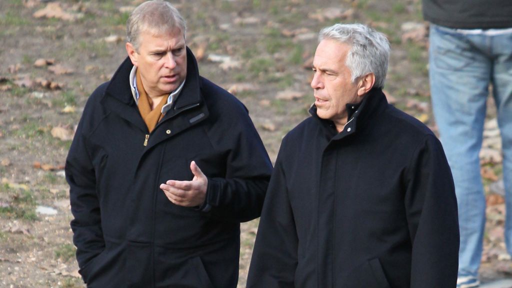 Prince Andrew and Jeffrey Epstein talk as they walk together in a park