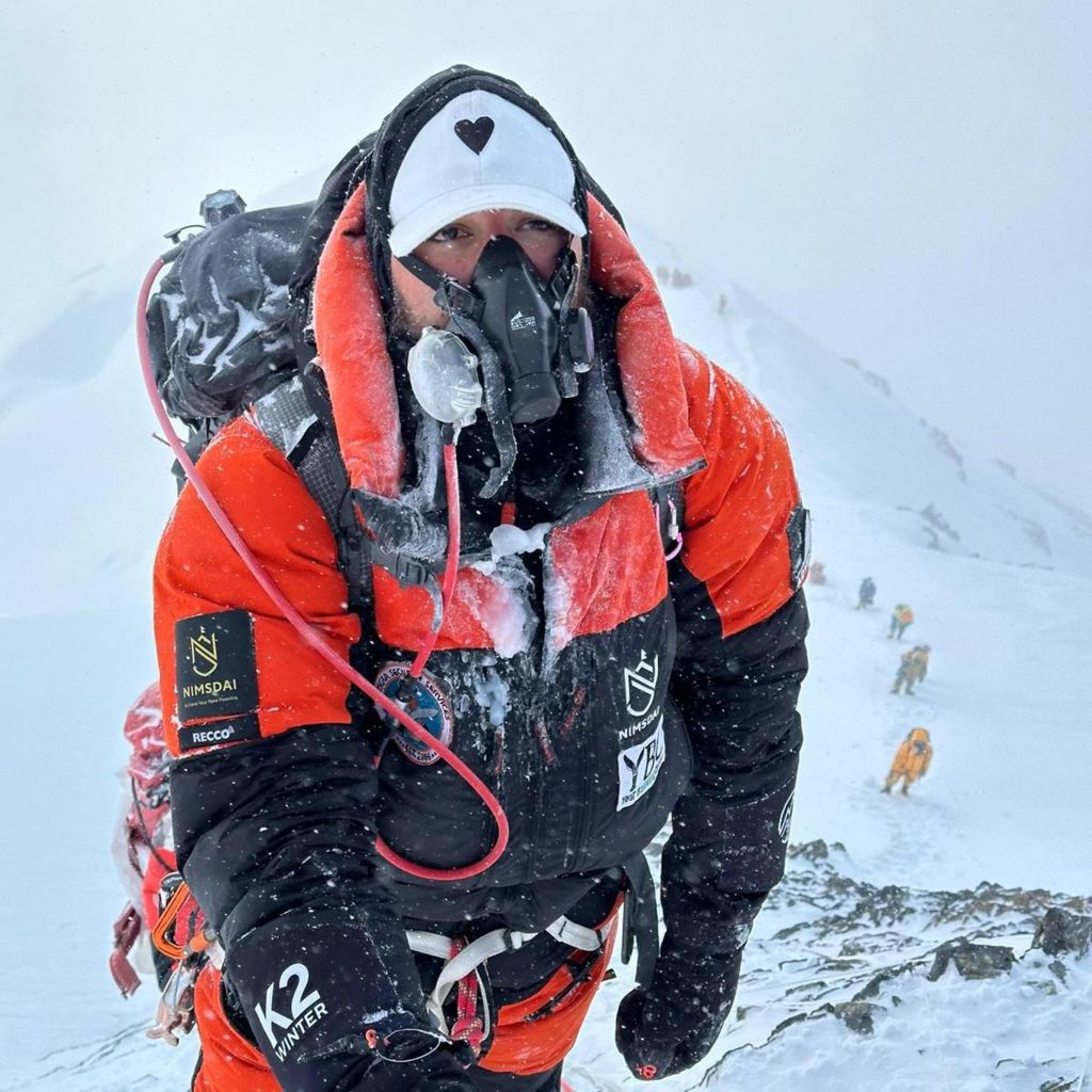 A man in mountain gear crusted with ice