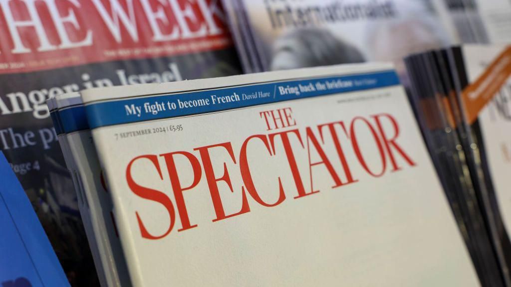 The 7 September 2024 edition of The Spectator magazine seen on a news stand, with other publications around it