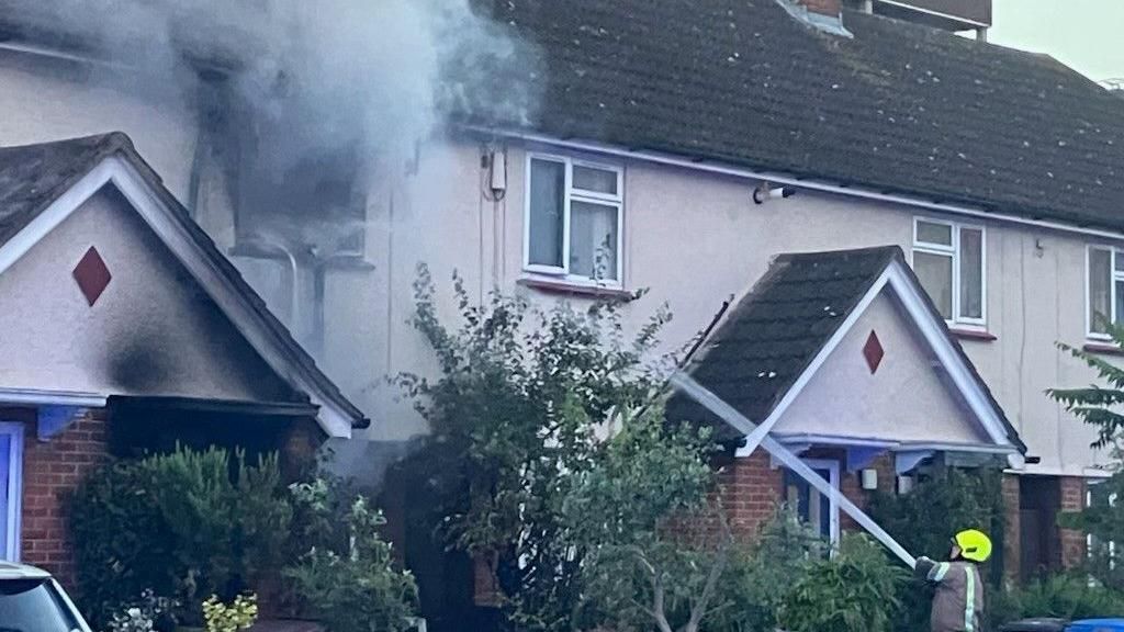 A firefighter extinguishing the house fire in Portman Road