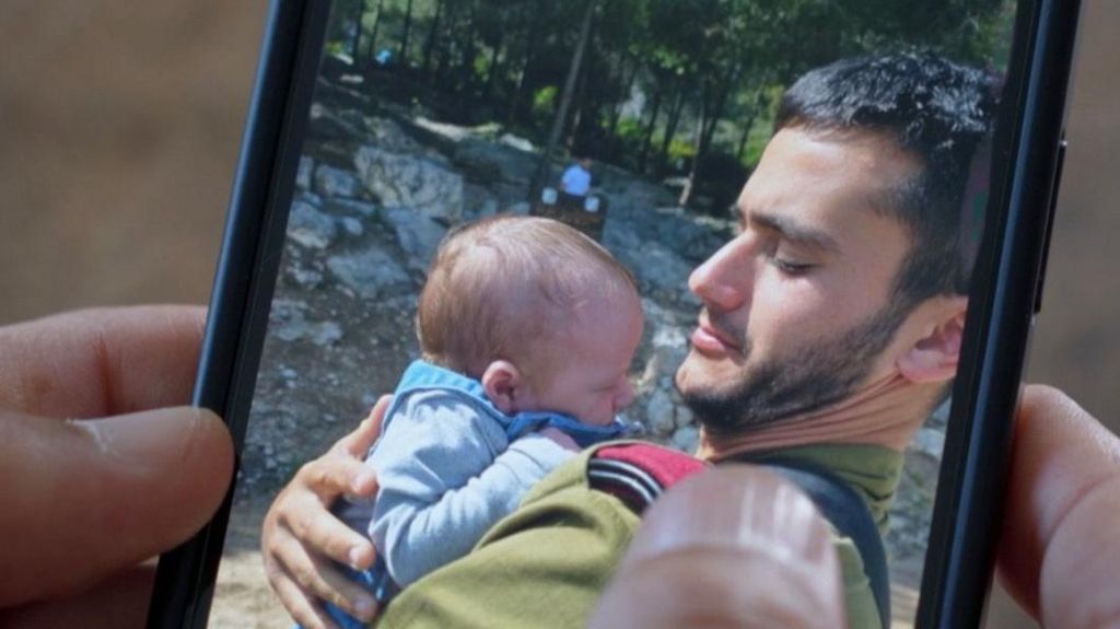 Image on mobile phone of Reef Harush holding newborn cousin days before he was killed.