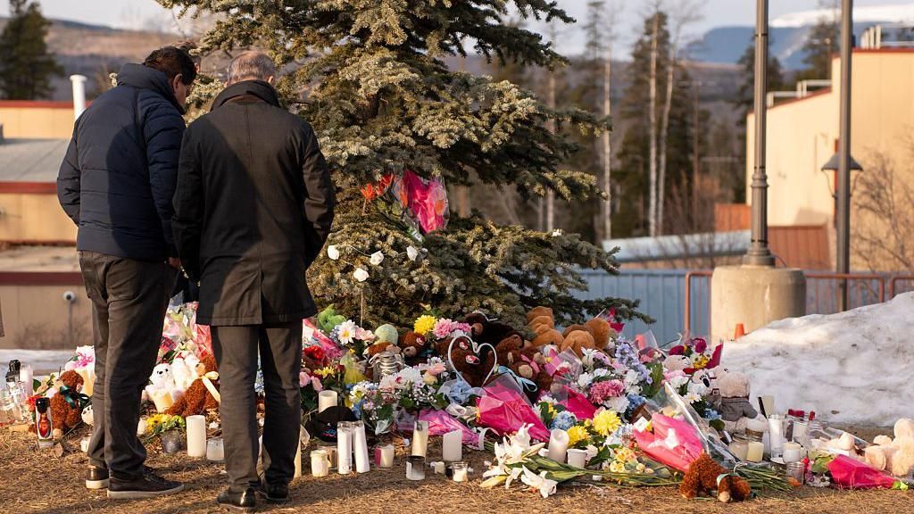 Flowers and tributes left outside Tumbler Ridge school after the shooting