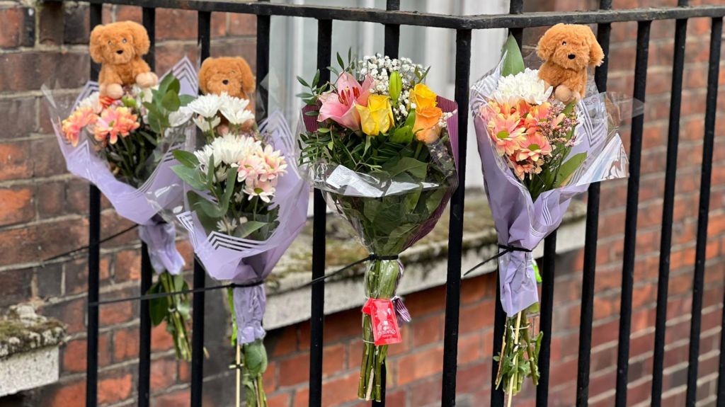 Pictures of flowers and a toy animal left near the Peabody Estate building in Horseferry Road in central London