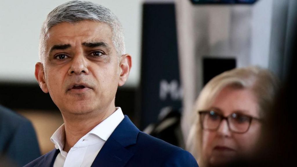 Sadiq Khan with susan hall in the background