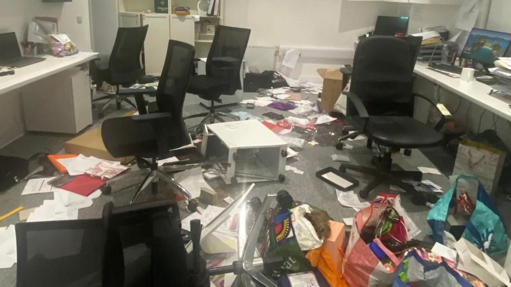 Office with furniture and belongings thrown around