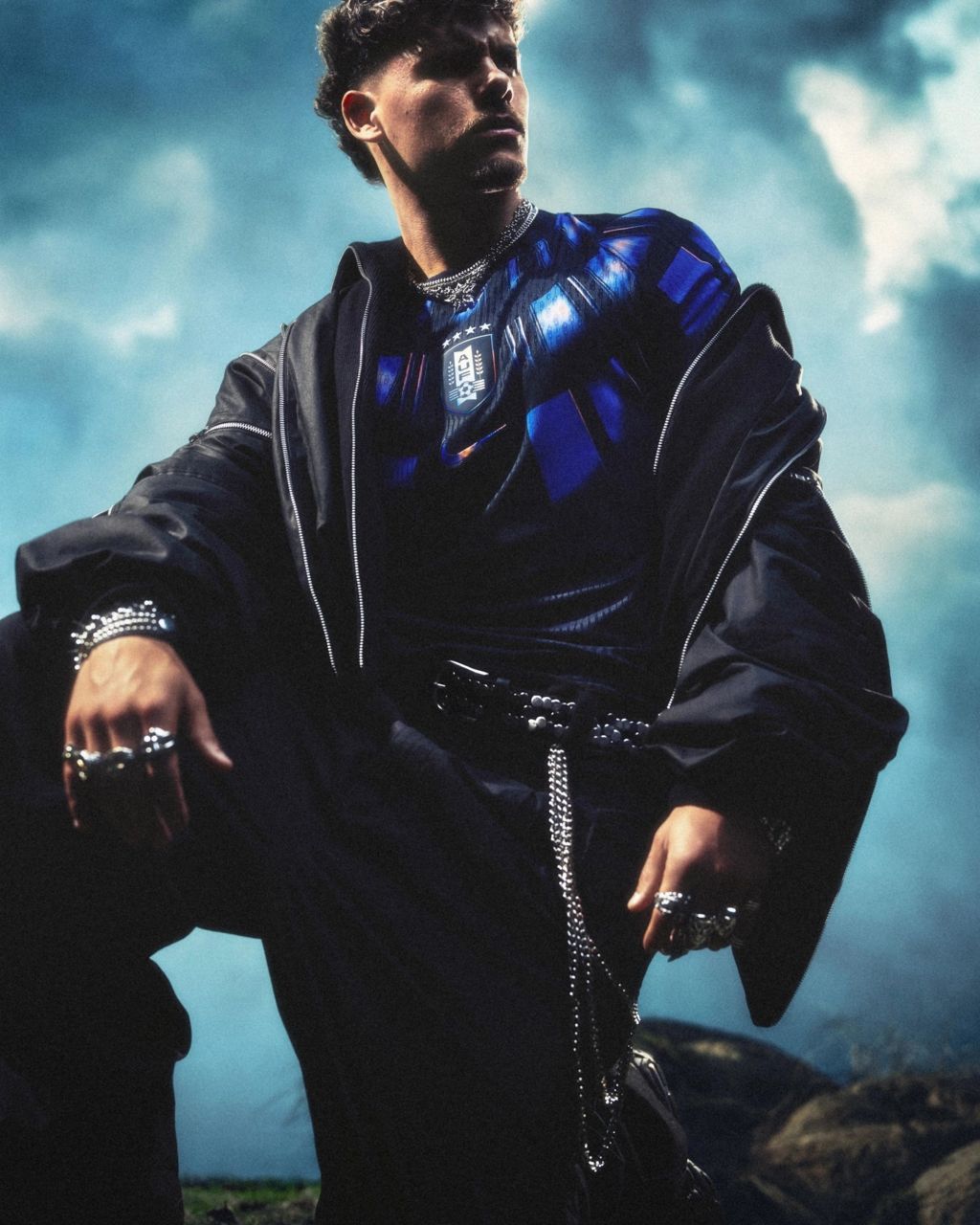 Ronald Araújo wears the Uruguay home kit with chunky silver accessories, an oversized jacket and baggy trousers