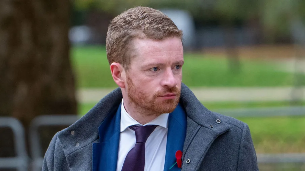 Morgan McSweeney, former Downing Street Chief of Staff, seen in Westminster, London, 5 November 2025. He was wearing a grey coat over a blue suit, white shirt and purple tie.