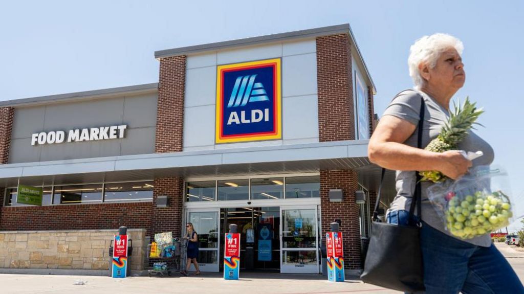  A customer walks out of an Aldi supermarket on August 17, 2023 in Pflugerville, Texas.