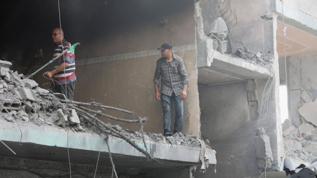 Palestinians inspect a house hit in an Israeli strike, due to an Israeli military operation, amid the Israel-Hamas conflict, in Nuseirat refugee camp in the central Gaza Strip