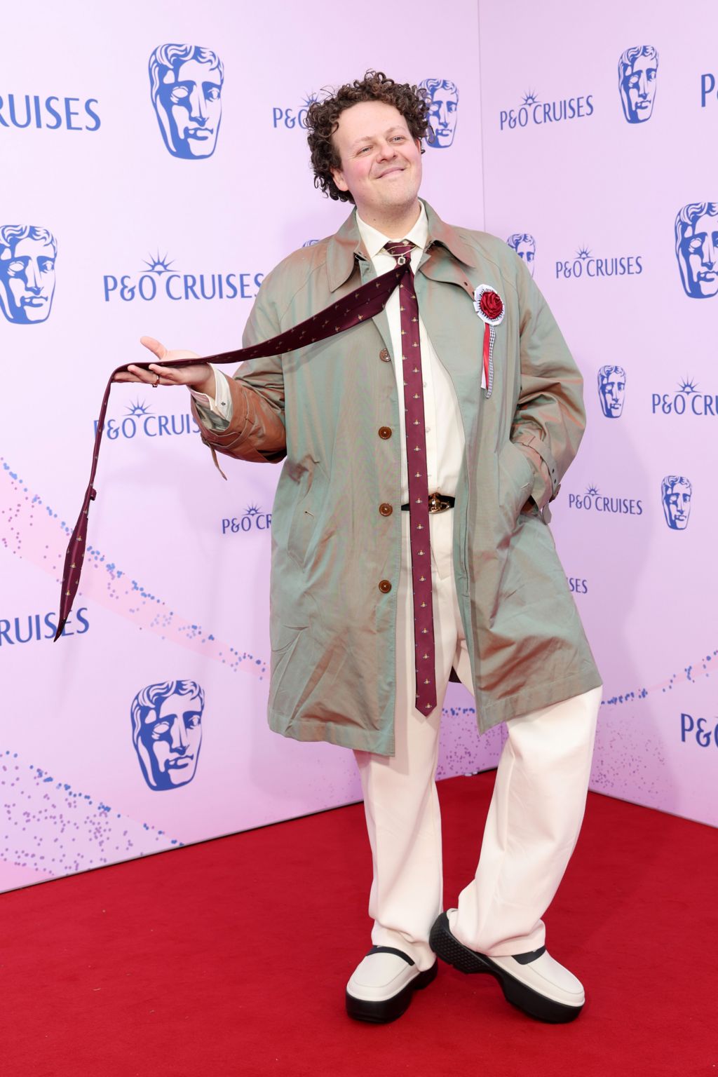 Jack Rooke twirling a very long maroon tie