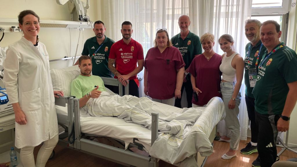 Barnabas Varga in hospital bed surrounded by friends, coaches and team-mates