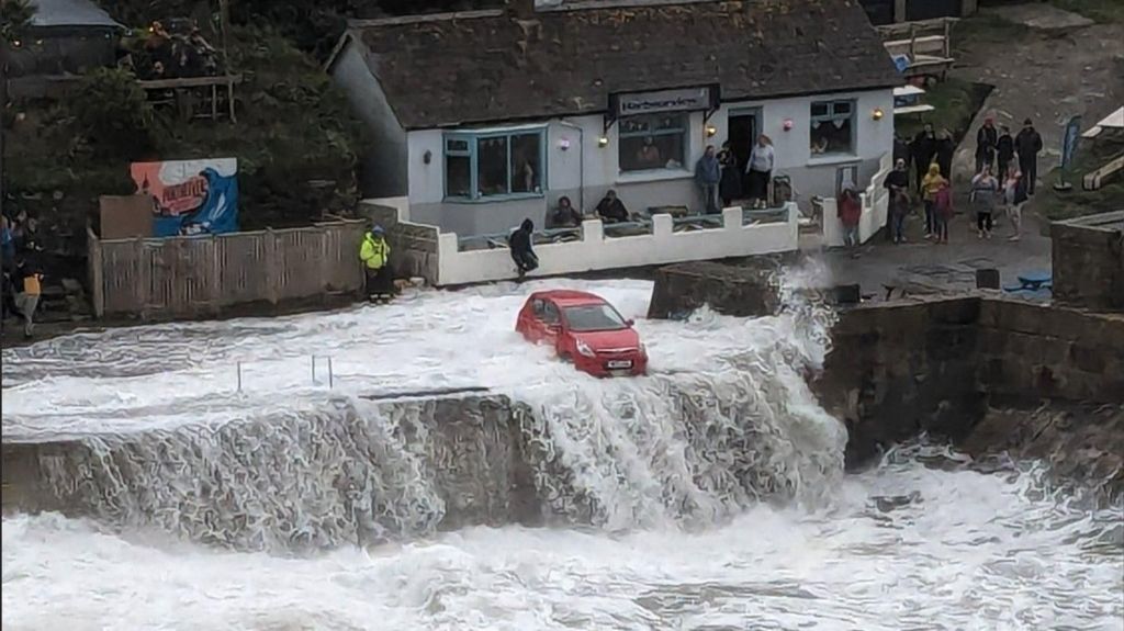Car in the waves at Porthleven