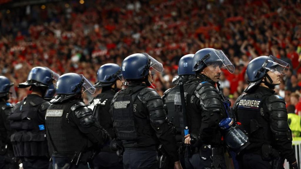 French riot police in front of Liverpool supporters at the end of the UEFA Champions League final between Liverpool FC and Real Madrid at Stade de France in Saint-Denis, near Paris, France