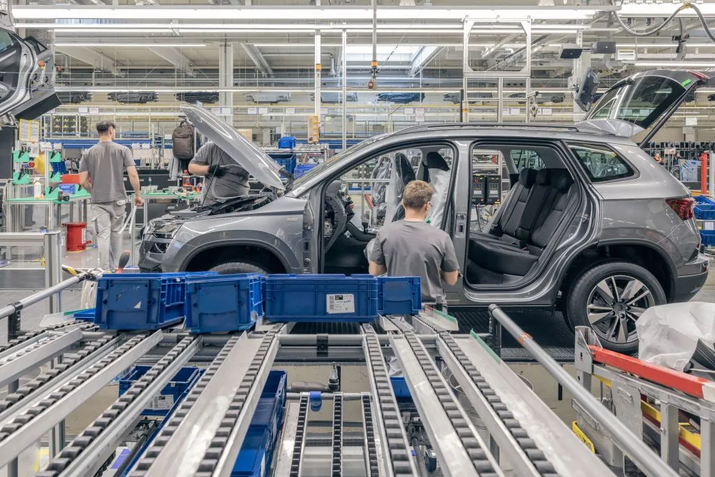 Workers at a Volkswagen factory in Slovakia, and a car under assembly