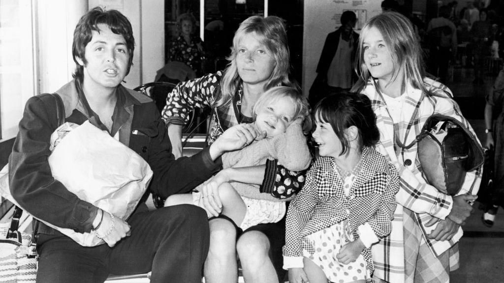 Paul McCartney poses with his wife Linda (1941 - 1998), and their daughters, left to right, Stella, Mary, and Heather, at Heathrow Airport in London, England, 2nd August 1974