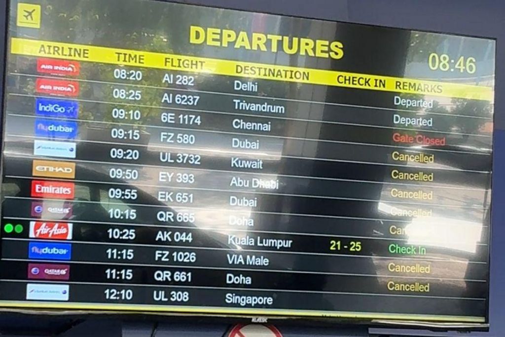 A TV showing a list of flights, destinations and many cancellations