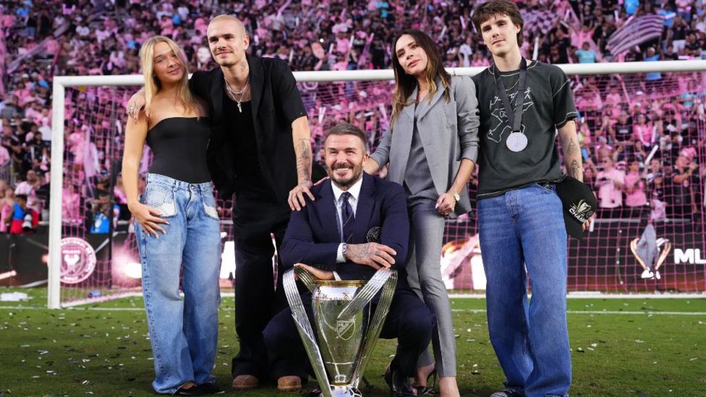 Sir David Beckham, co-owner of Inter Miami CF, and Victoria Beckham pose with the trophy with Cruz Beckham, Romeo Beckham after winning the Championship following the Audi 2025 MLS Cup Final match between Inter Miami CF and Vancouver Whitecaps FC at Chase Stadium on December 06, 2025 in Fort Lauderdale, Florida
