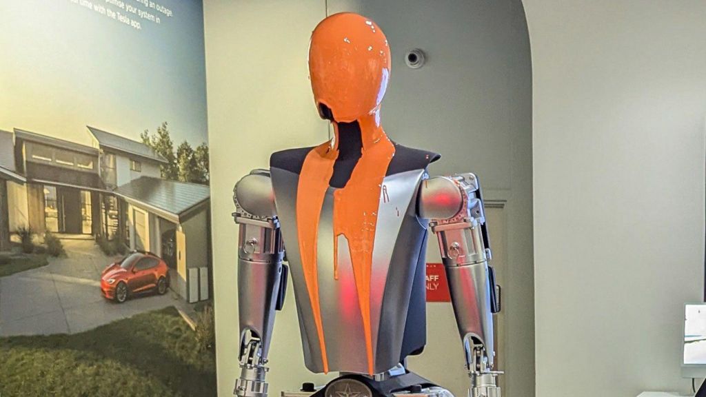 Orange liquid latex drips down a robot
