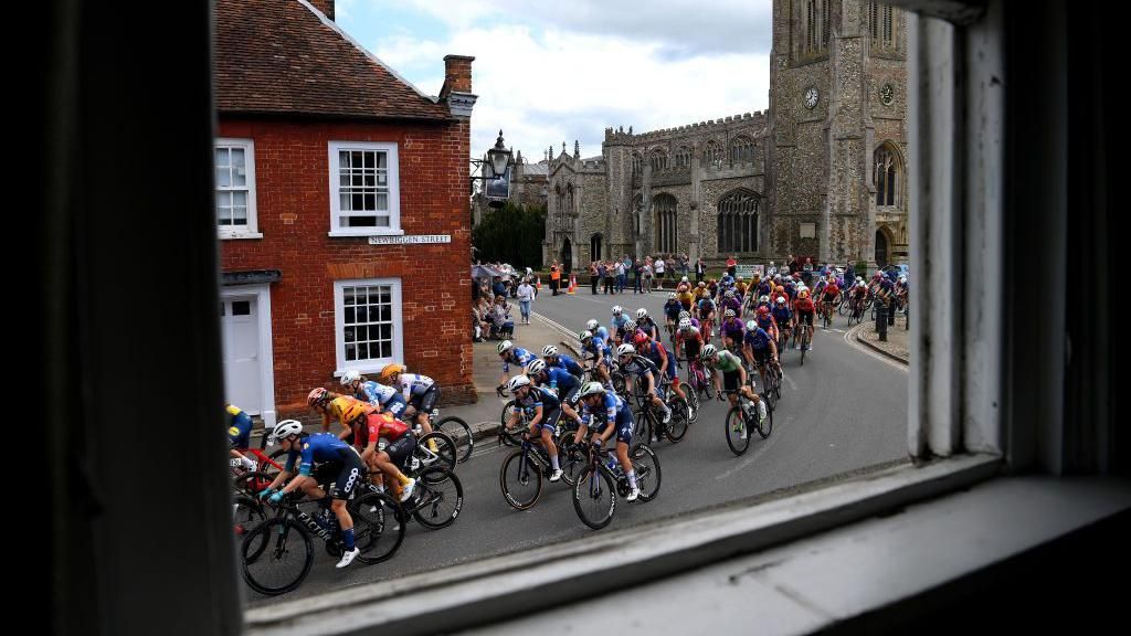 General view of the peloton passing Thaxted village during the 10th Ford RideLondon Classique 2024