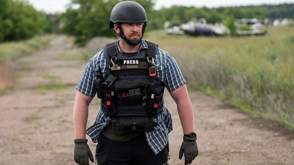 Reuters safety advisor Ryan Evans stands in a field in an undated photo taken in Ukraine.