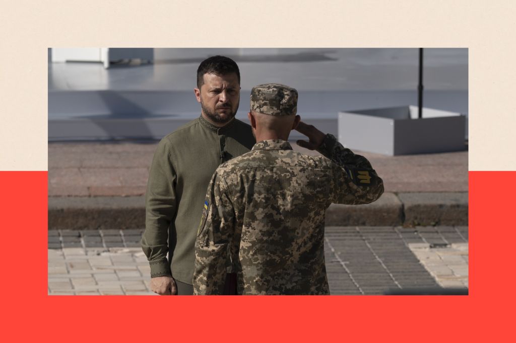 Volodymyr Zelensky receives a salute from a Ukrainian soldier