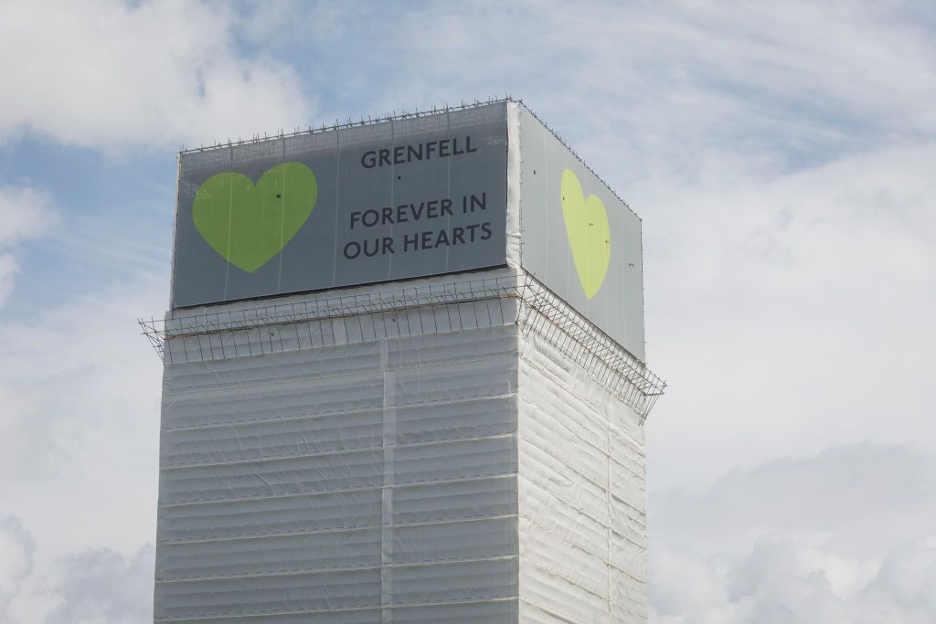 The covered remains of the Grenfell high rise, on the first anniversary of the tower block disaster