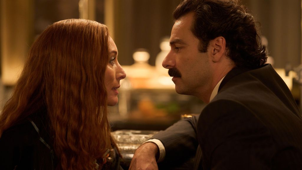 Victoria Smurfit and Aidan Turner facing each other in formal dress