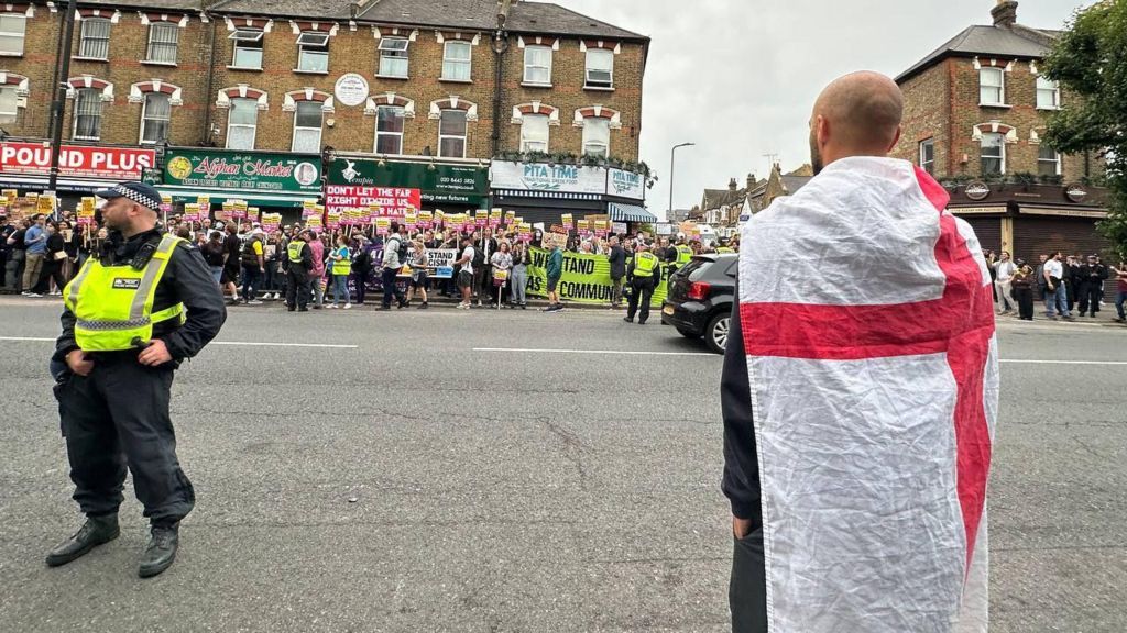 A protester wearing an England flag turned out in Finchley, north London on 7 August