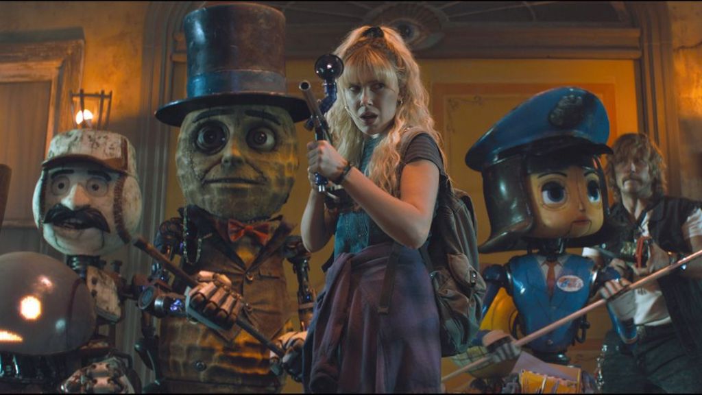 Millie Bobby Brown holding up a gun, flanked by three robot characters and Chris Pratt in a row in Electric State