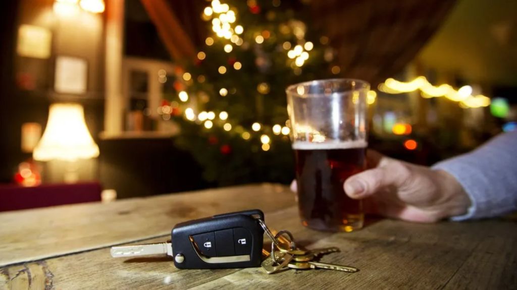 A pint of beer next to a set of car keys