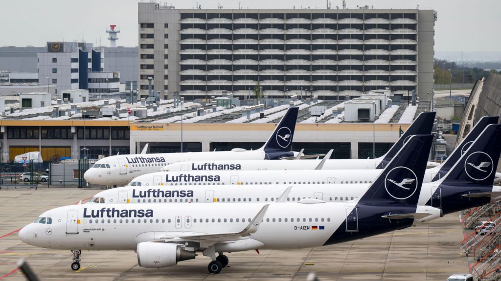 Parked Lufthansa aircraft are lined up at Frankfurt Airport on April 13, 2026.