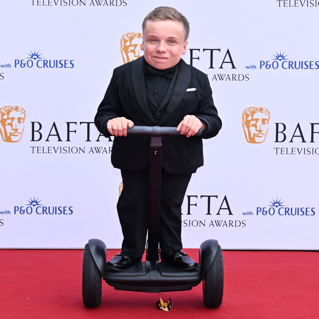 Lenny Rush on a segway-style scooter on the red carpet