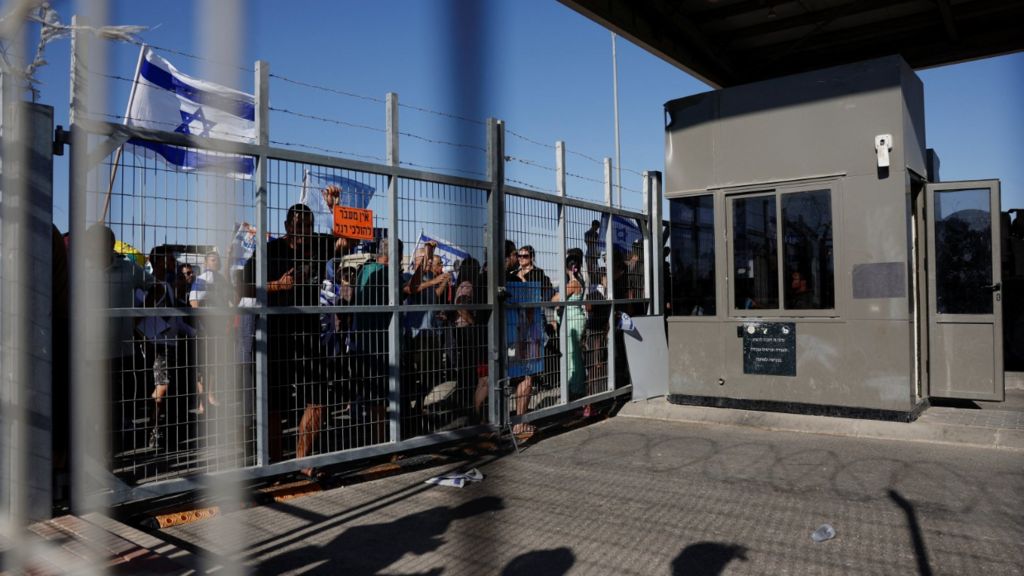 Protesters gather outside Sde Teiman detention facility after some of them broke in, after Israeli military police arrived at the site as part of an investigation into the suspected abuse of a Palestinian detainee, near Beersheba