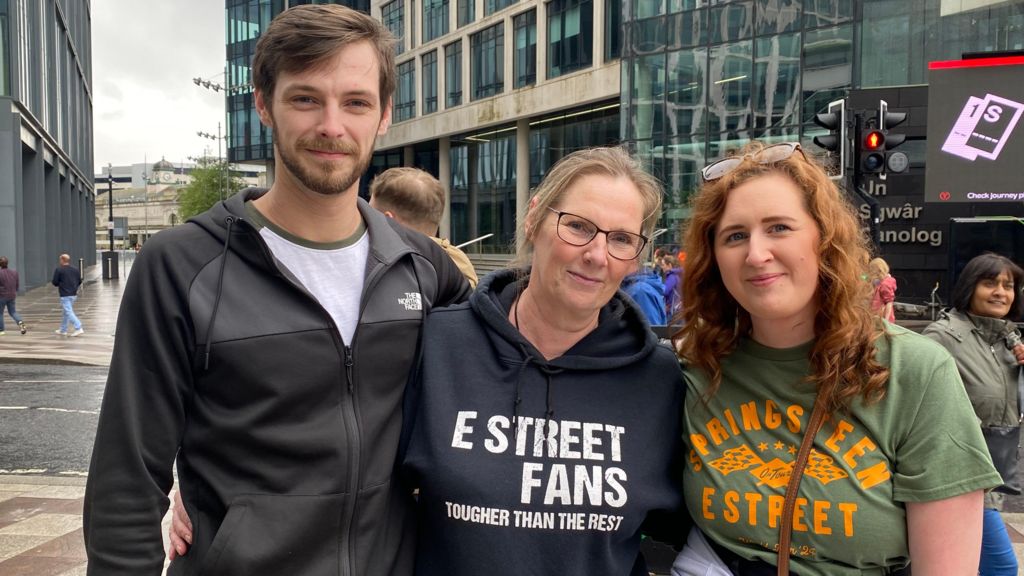 A man stood with two women