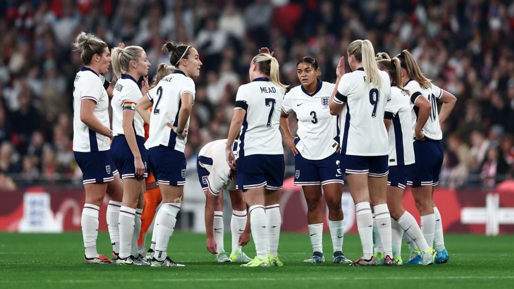 England players in a huddle after conceding their third goal